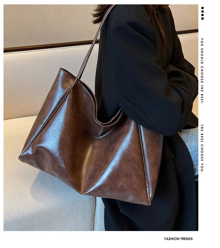 Brown leather tote bag for women, stylish and spacious, perfect for daily fashion or travel use.