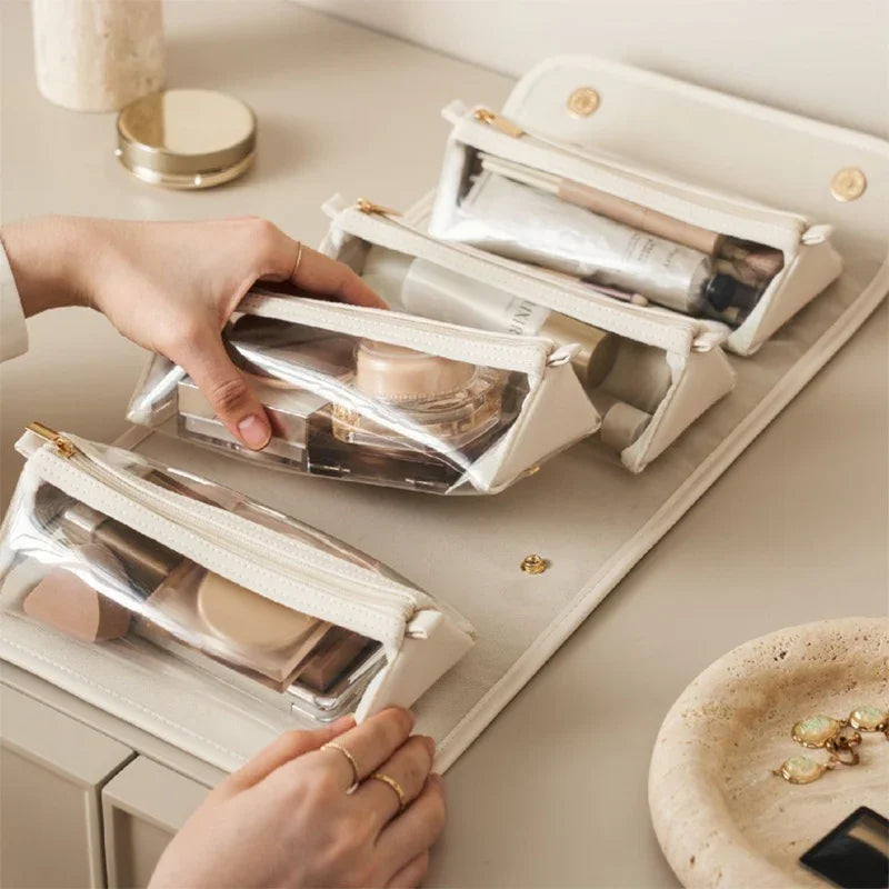 Clear travel makeup bags with gold zippers, neatly organizing cosmetics for stylish travel.