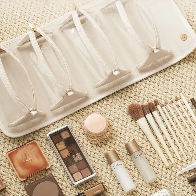 Travel makeup organizer with clear pockets, holding brushes, palettes, and skincare for stylish on-the-go beauty