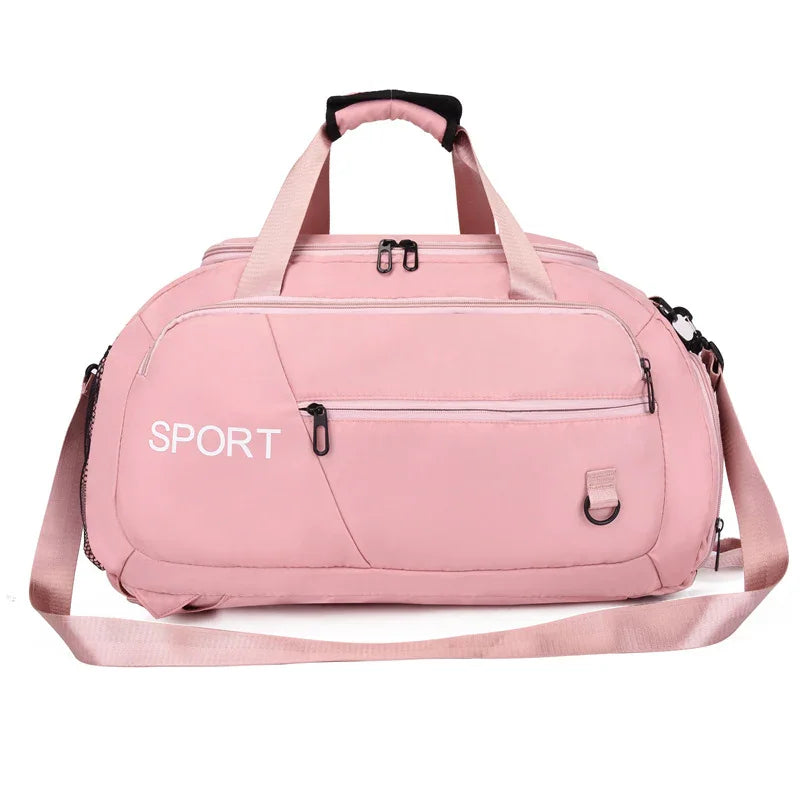 Pink sport duffel bag with adjustable shoulder strap, multiple zippers, and 'SPORT' text for gym or travel use