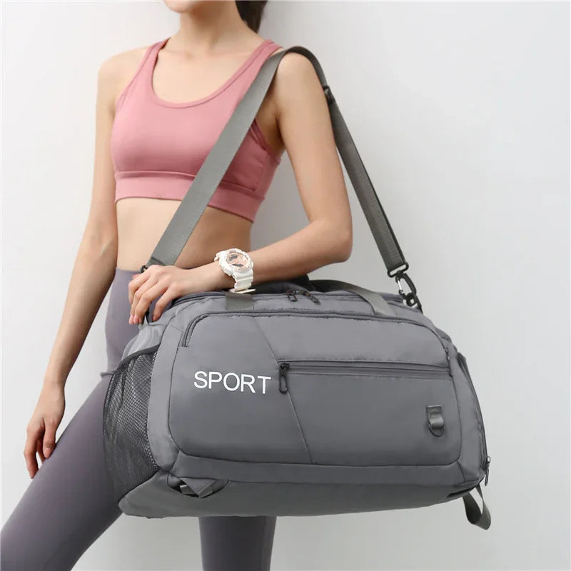 Gray sport duffel bag with mesh side pocket, ideal for gym or travel