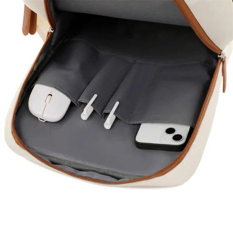 Organized bag interior with phone, mouse, and earbuds in compartments