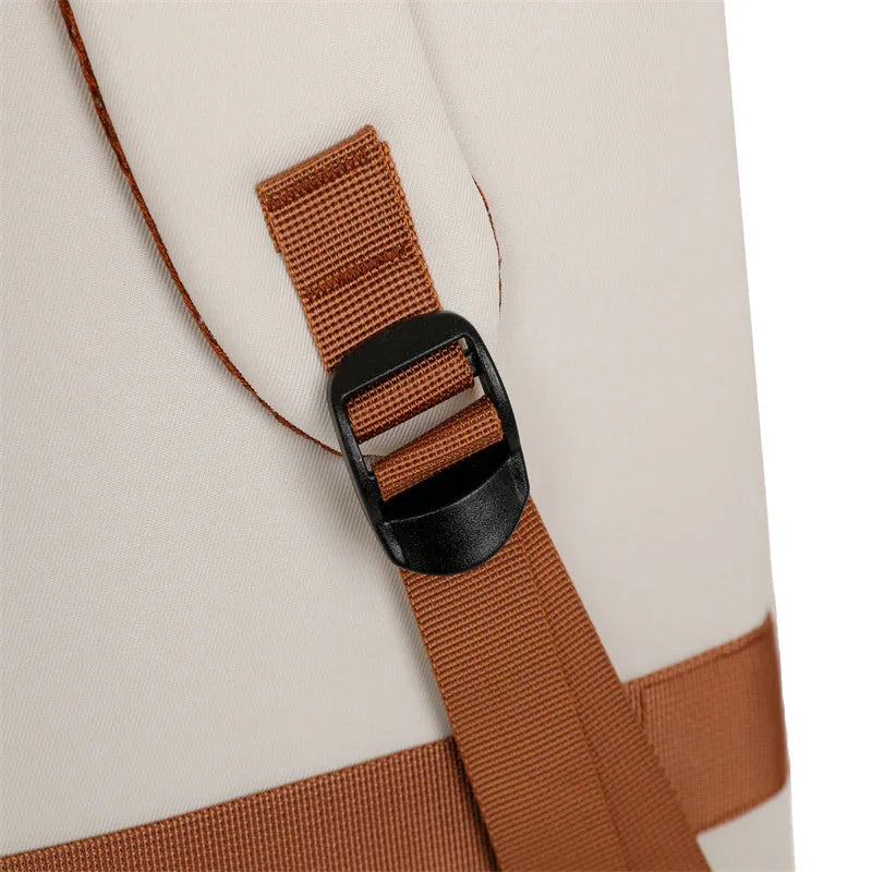 Beige travel bag with brown straps and black buckle for secure fastening