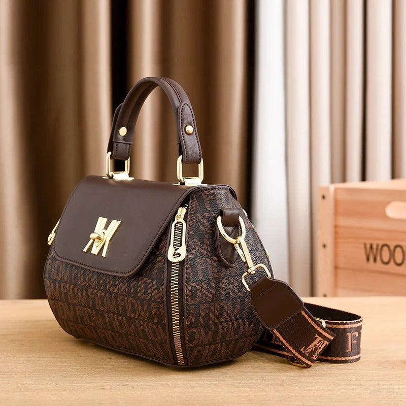 Brown monogram handbag with gold hardware, top handle, and detachable strap for women's fashion