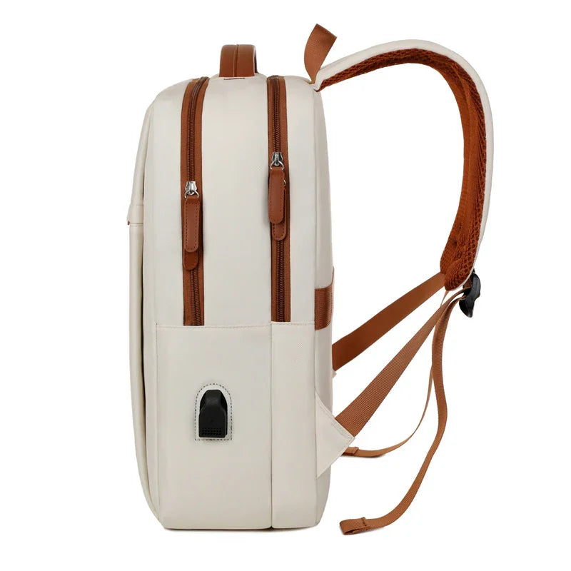 Cream backpack with brown straps and zippers, featuring a USB port for travel convenience