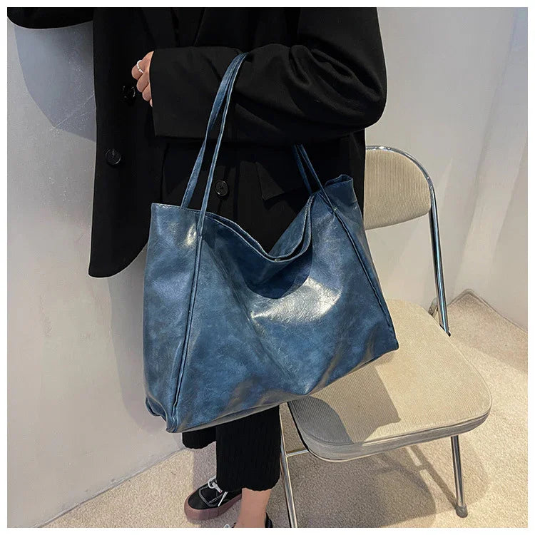 Stylish blue leather tote bag for women, perfect for everyday use and travel