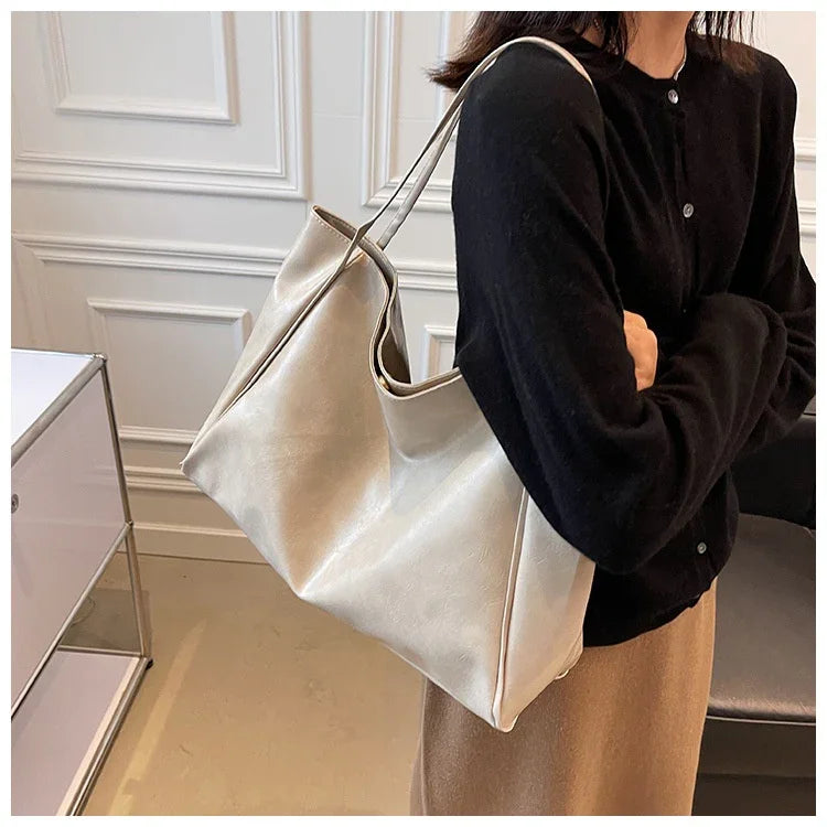 Stylish beige tote bag for women, perfect for daily use or travel, shown with black top and beige skirt.