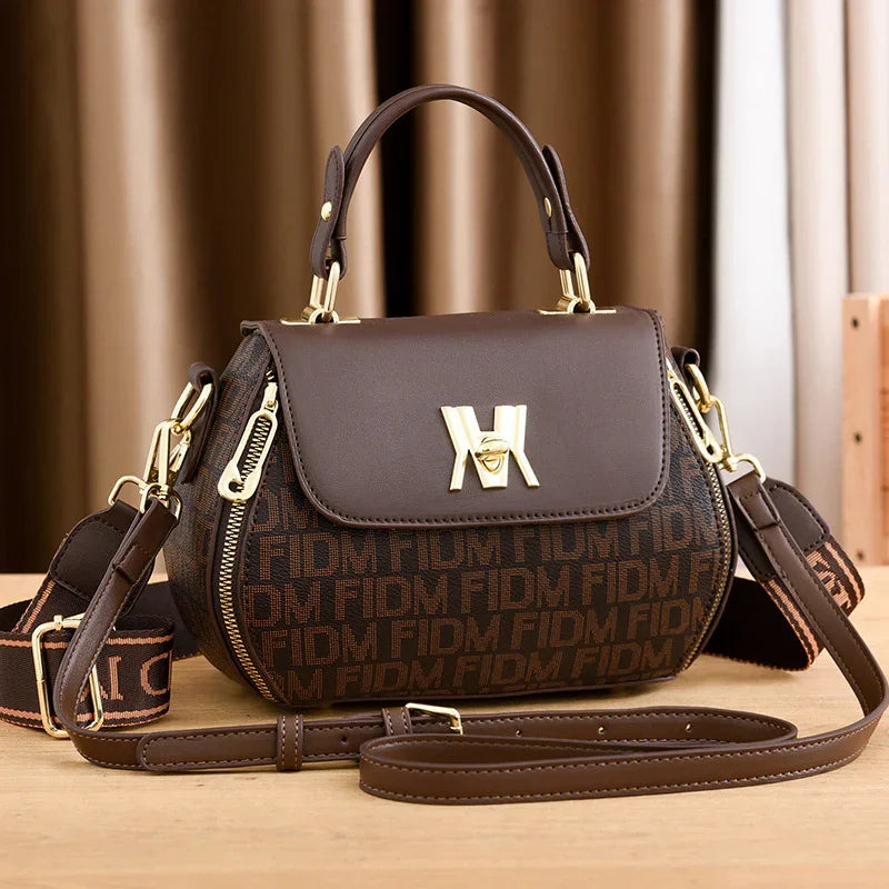 Stylish brown handbag with gold hardware and patterned design, perfect for fashion and travel