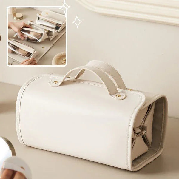 Cream leather travel bag with top handle, shown open with packing compartments for wrinkle-free clothes storage